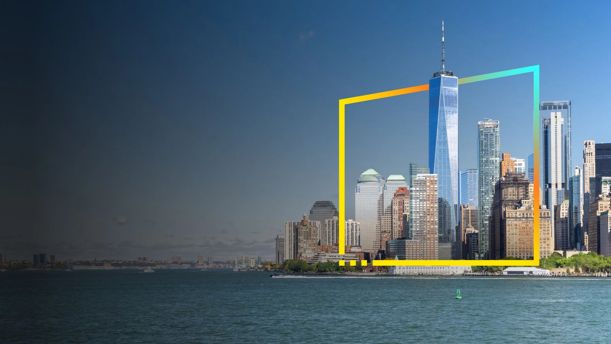 The skyline of New York City as seen from a distance with water in the foreground, and clear blue sky in the background.