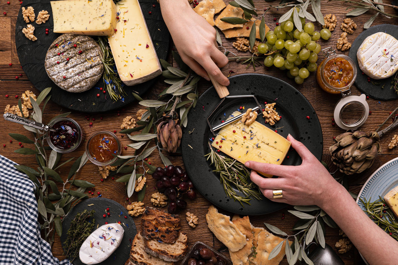 hands cut a piece of cheese