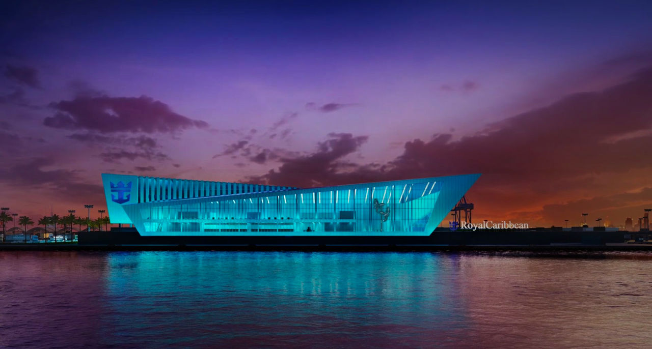 Royal Caribbean Miami Cruise Ship Terminal lit up blue on the water