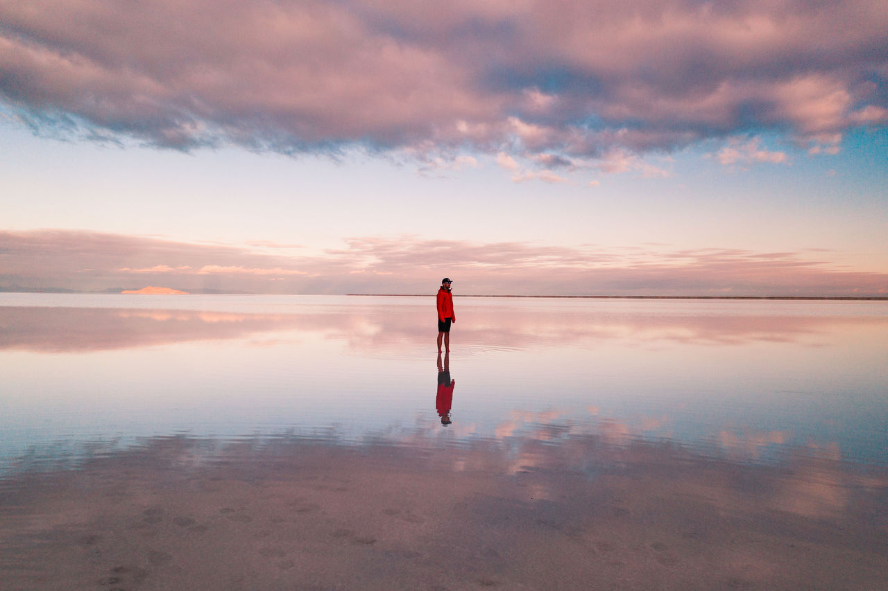person standing on the flooded Bonneville salt flats, Utah, USA