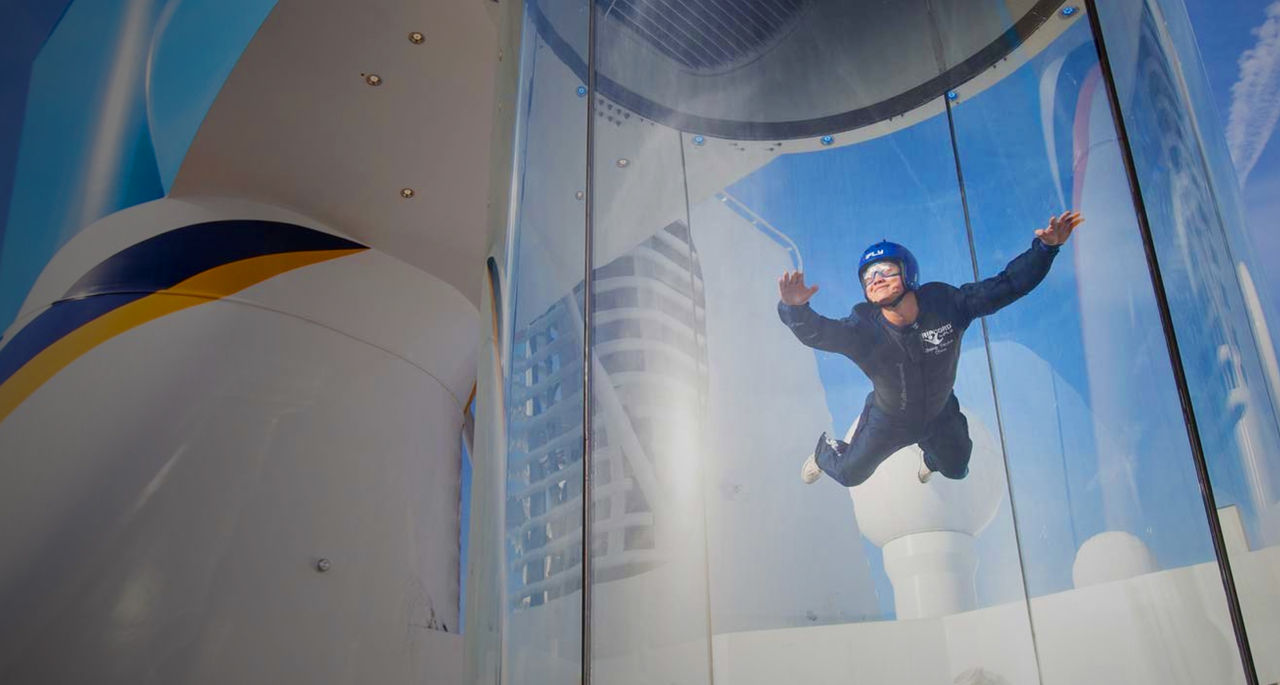A person floats inside a sky-diving simulator
